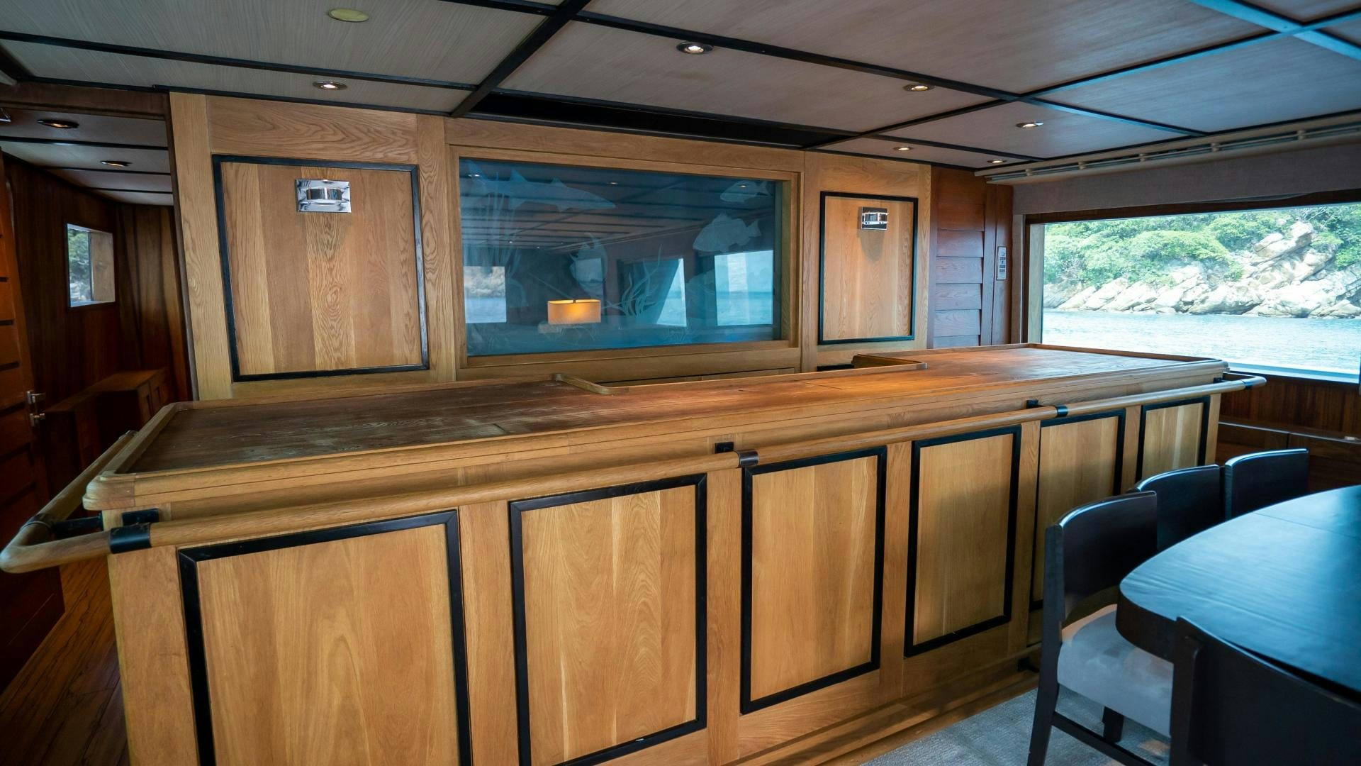a room with a large window and wood cabinets aboard MARAZUL Yacht for Sale