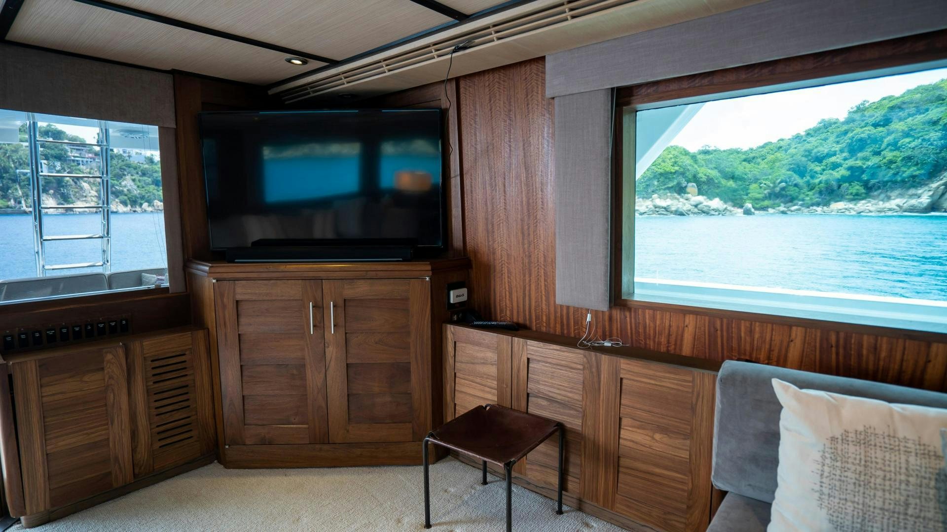 a room with a tv and a table aboard MARAZUL Yacht for Sale