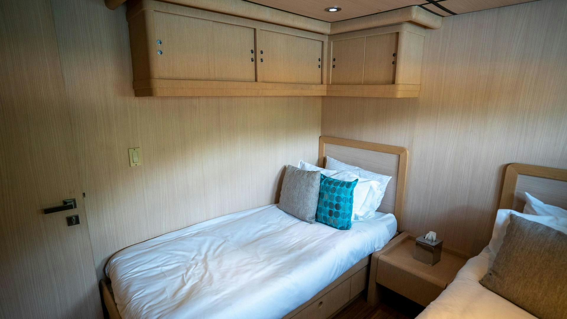 a room with a bed and a wooden wall aboard MARAZUL Yacht for Sale