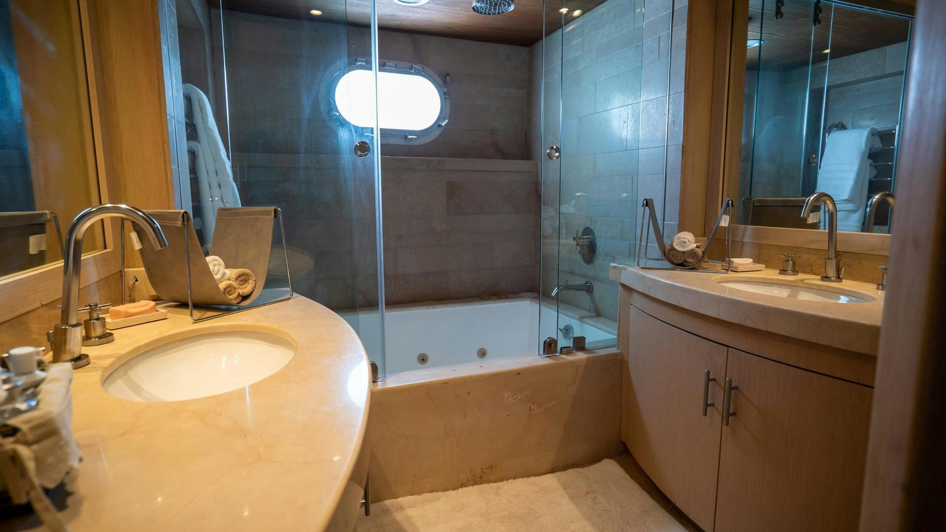 a bathroom with a tub sink and a sink aboard MARAZUL Yacht for Sale