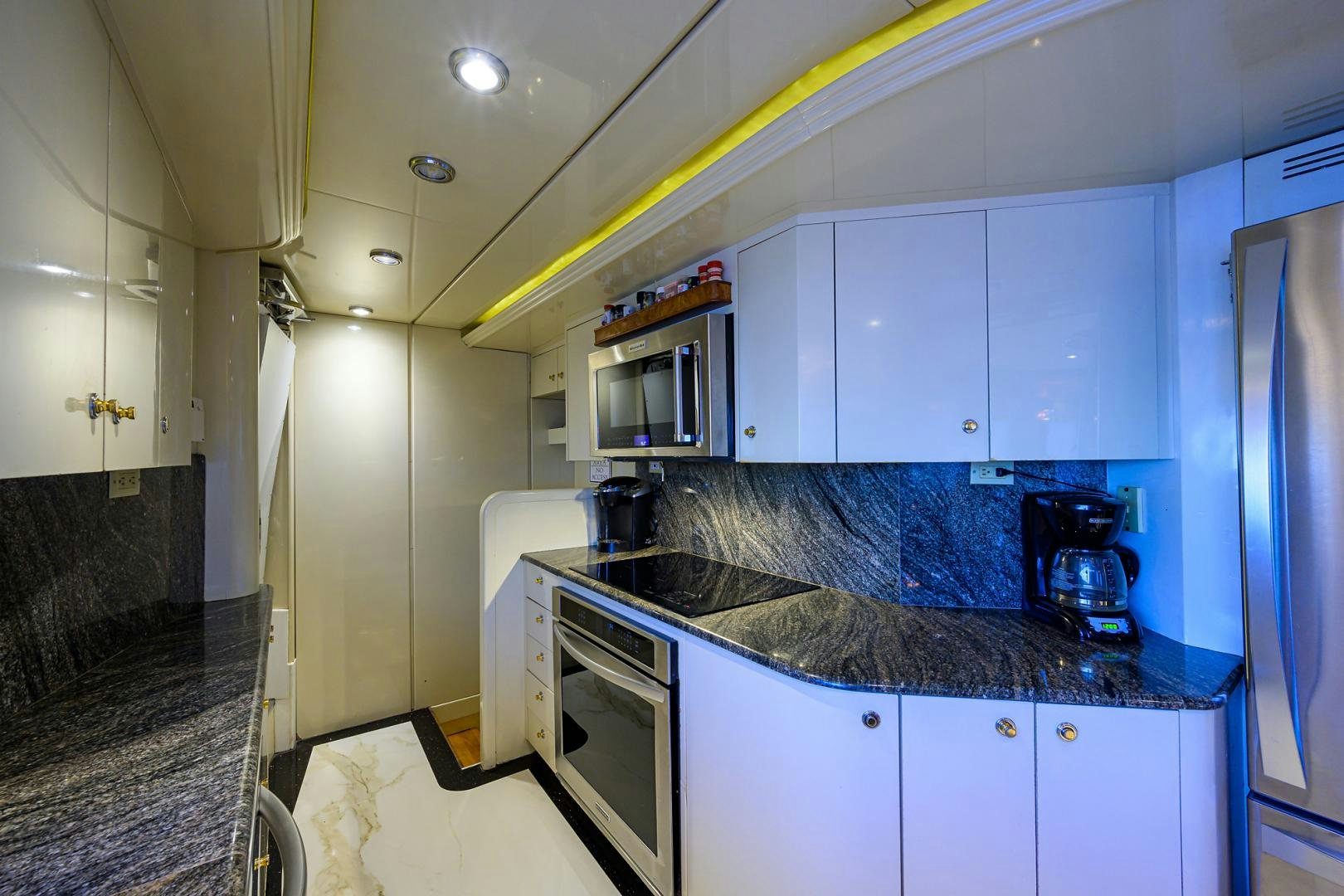 a kitchen with white cabinets aboard MY DESTINY Yacht for Sale