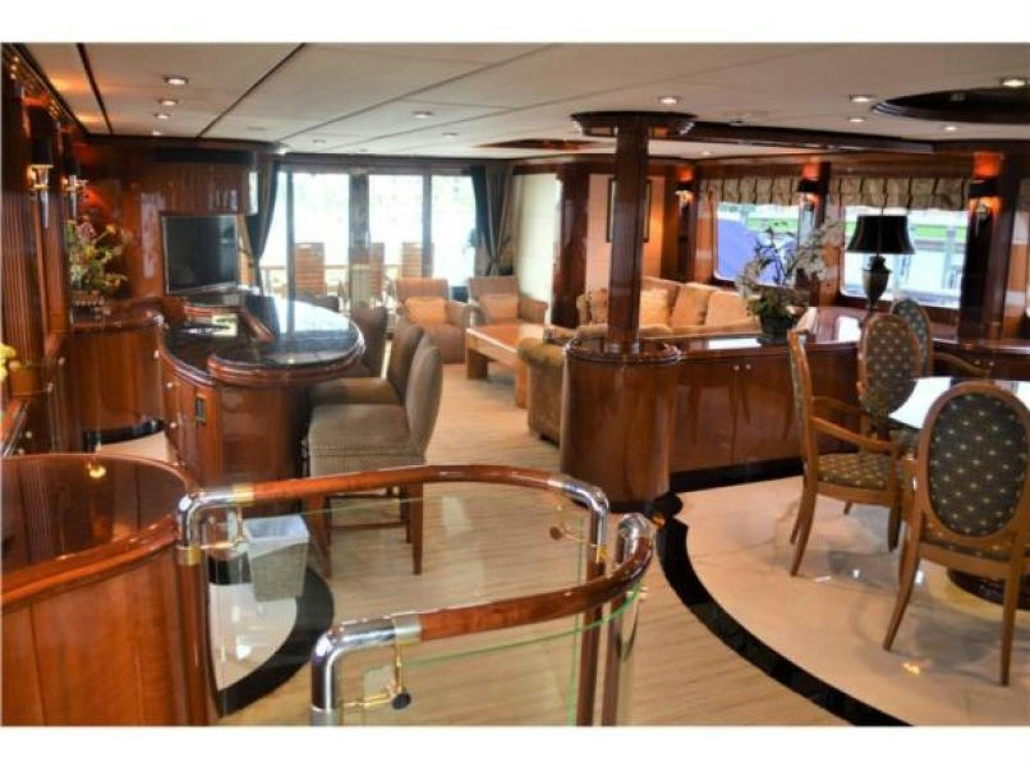 a room with a table chairs and a television aboard MY DESTINY Yacht for Sale