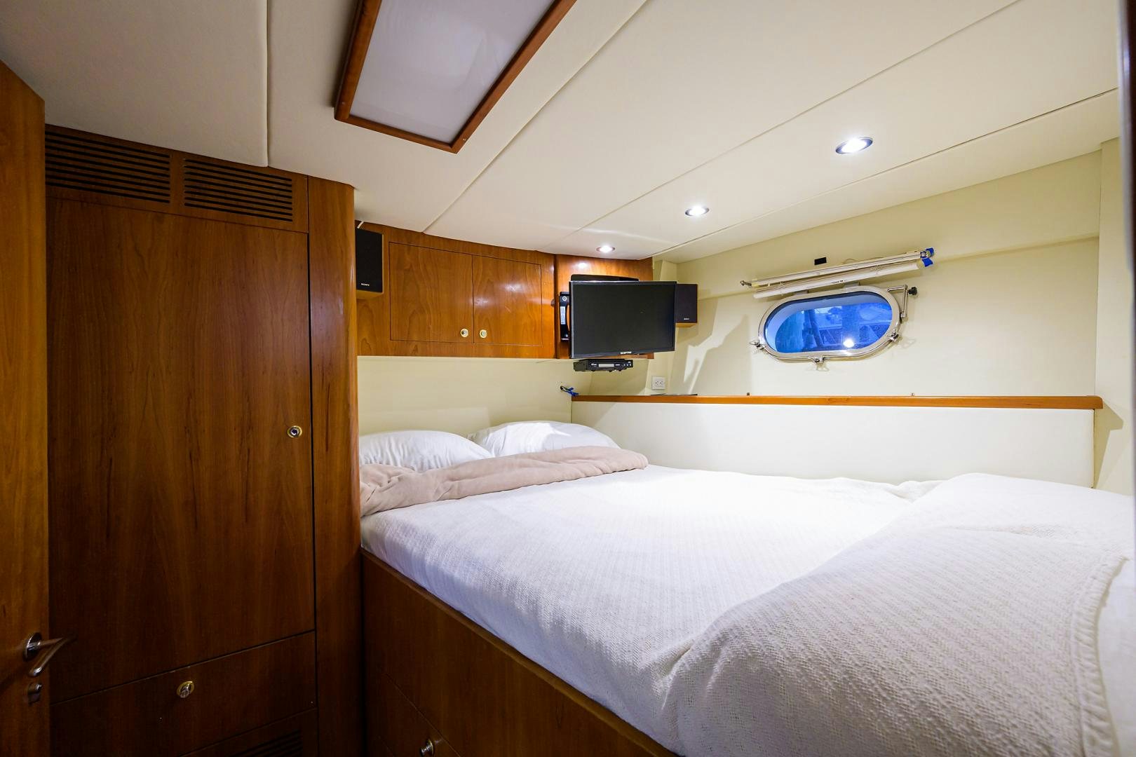 a room with a bed and a television aboard MY DESTINY Yacht for Sale