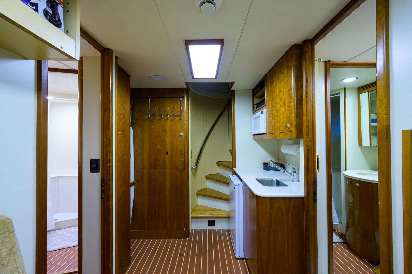 a kitchen with a sink and a hallway aboard MY DESTINY Yacht for Sale