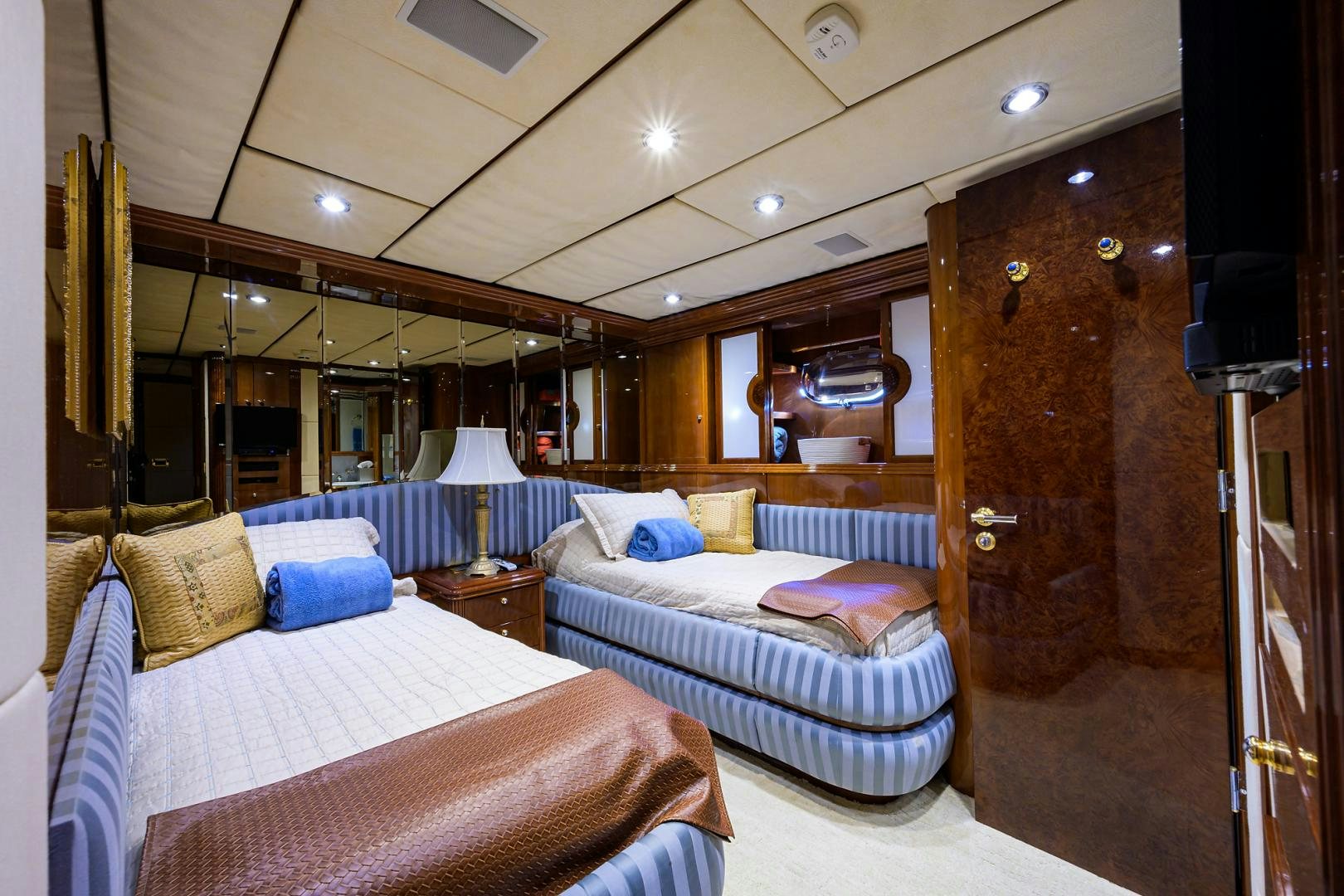 a bedroom with a bed and a mirror aboard MY DESTINY Yacht for Sale