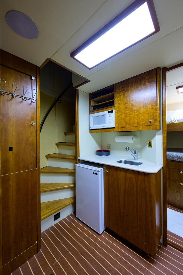 a kitchen with wooden cabinets aboard MY DESTINY Yacht for Sale