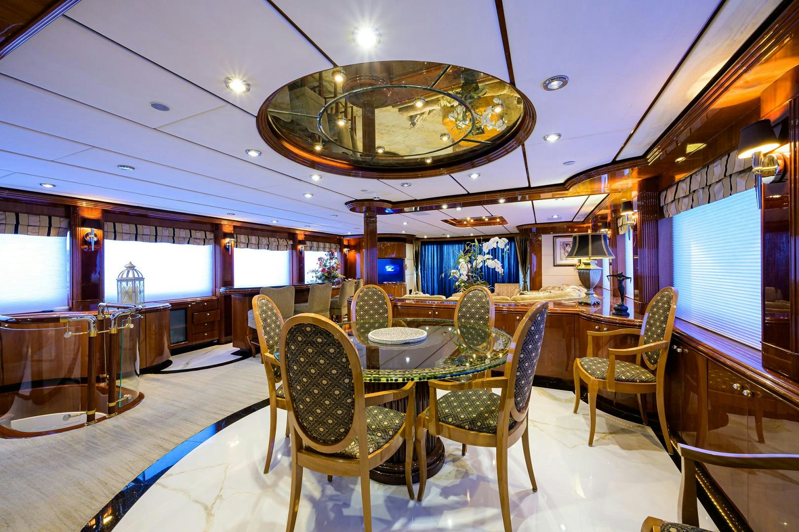 a room with a table chairs and a chandelier aboard MY DESTINY Yacht for Sale