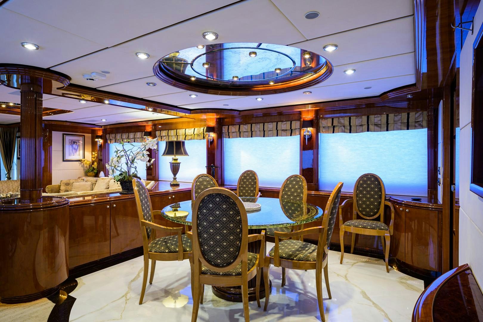 a room with a table chairs and a large chandelier aboard MY DESTINY Yacht for Sale