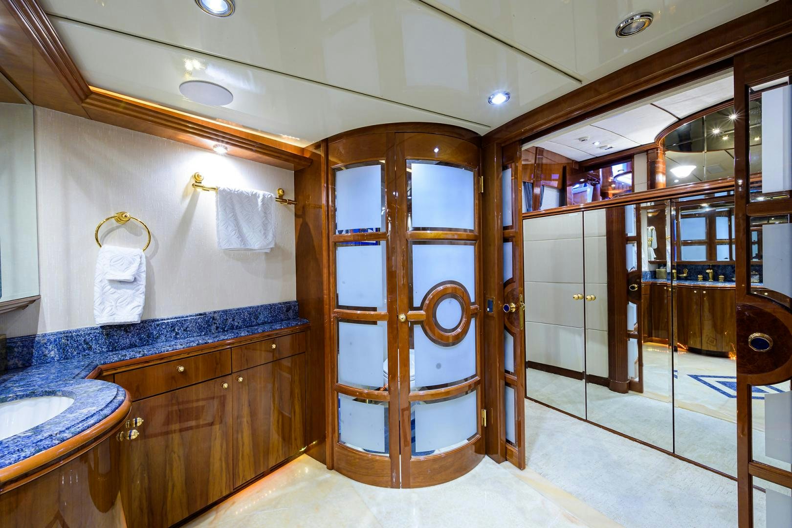 a bathroom with a wood door aboard MY DESTINY Yacht for Sale