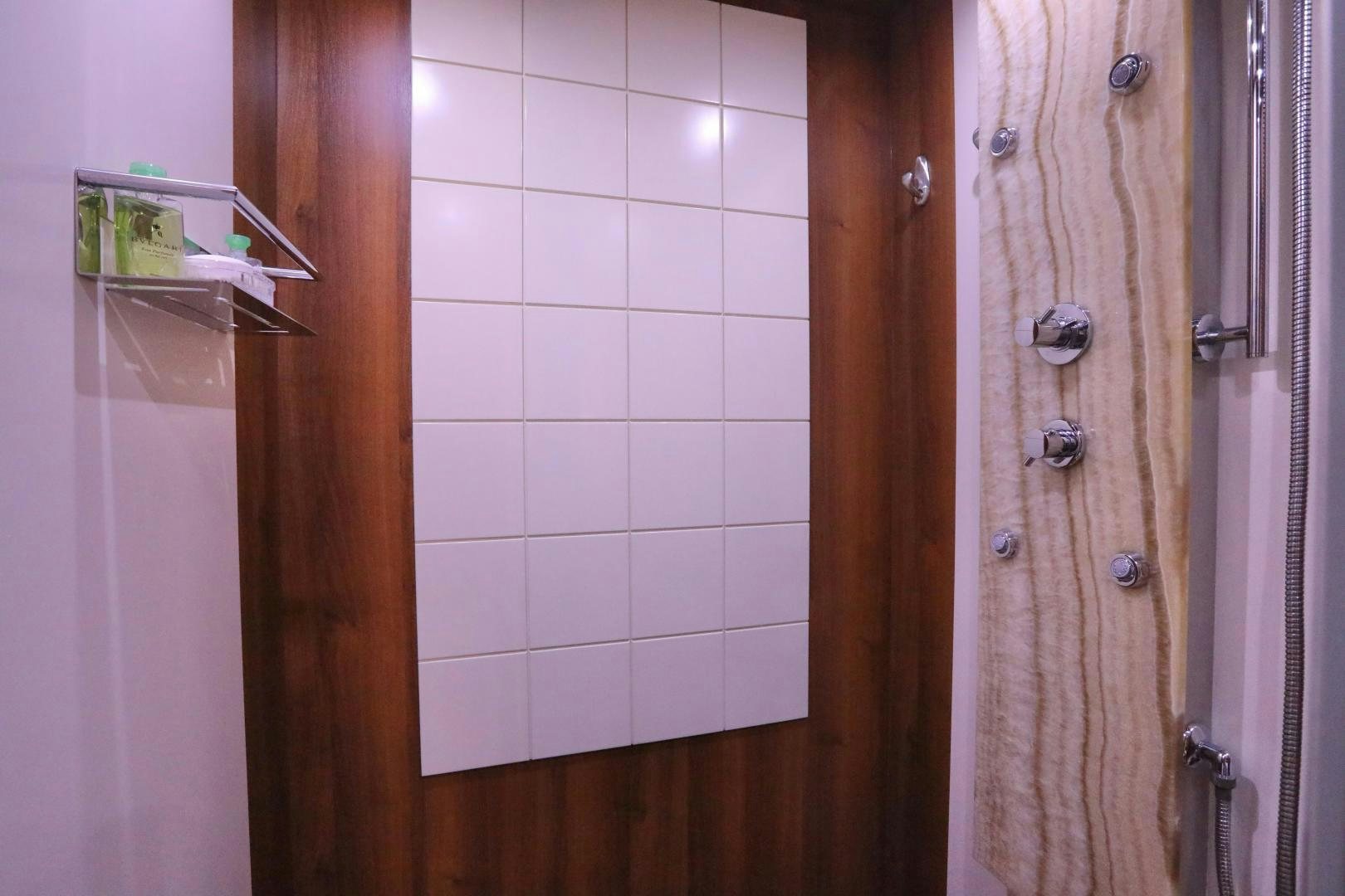 a white tiled shower aboard ANDREIKA Yacht for Sale