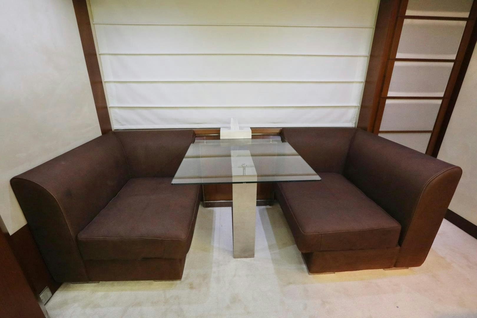 a couple of brown leather chairs next to a coffee table aboard ANDREIKA Yacht for Sale