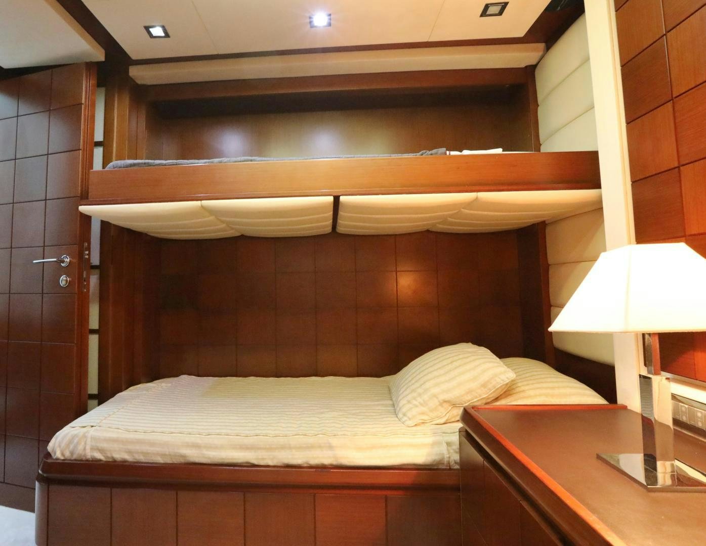 a bed with a wooden headboard aboard ANDREIKA Yacht for Sale