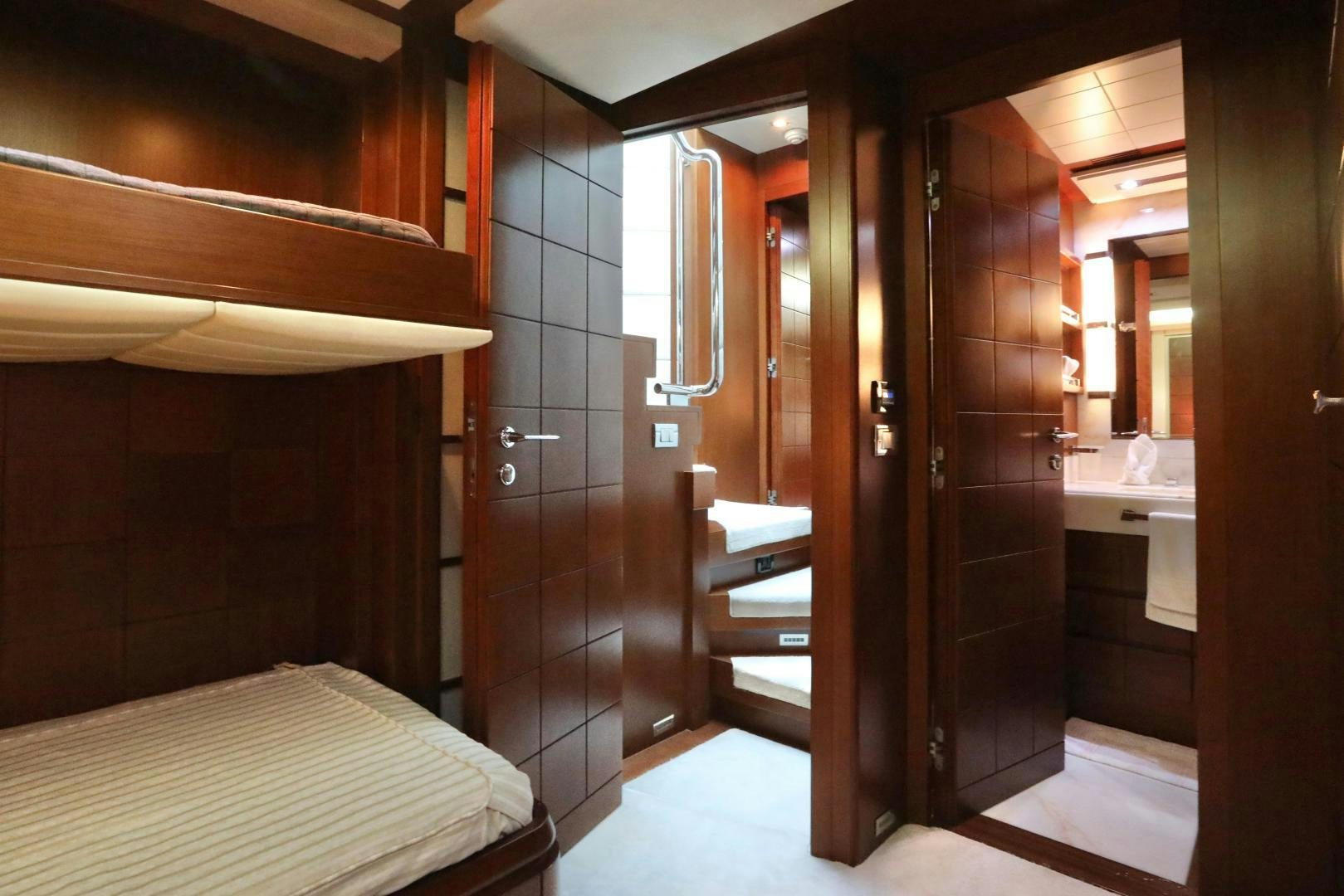 a bathroom with a bed and a sink aboard ANDREIKA Yacht for Sale