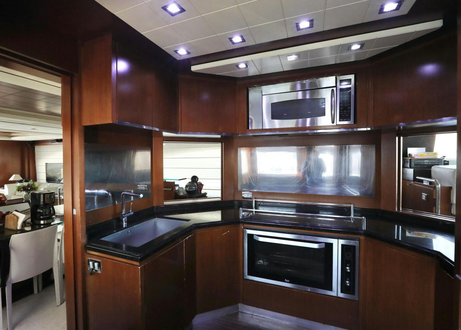 a kitchen with wooden cabinets aboard ANDREIKA Yacht for Sale