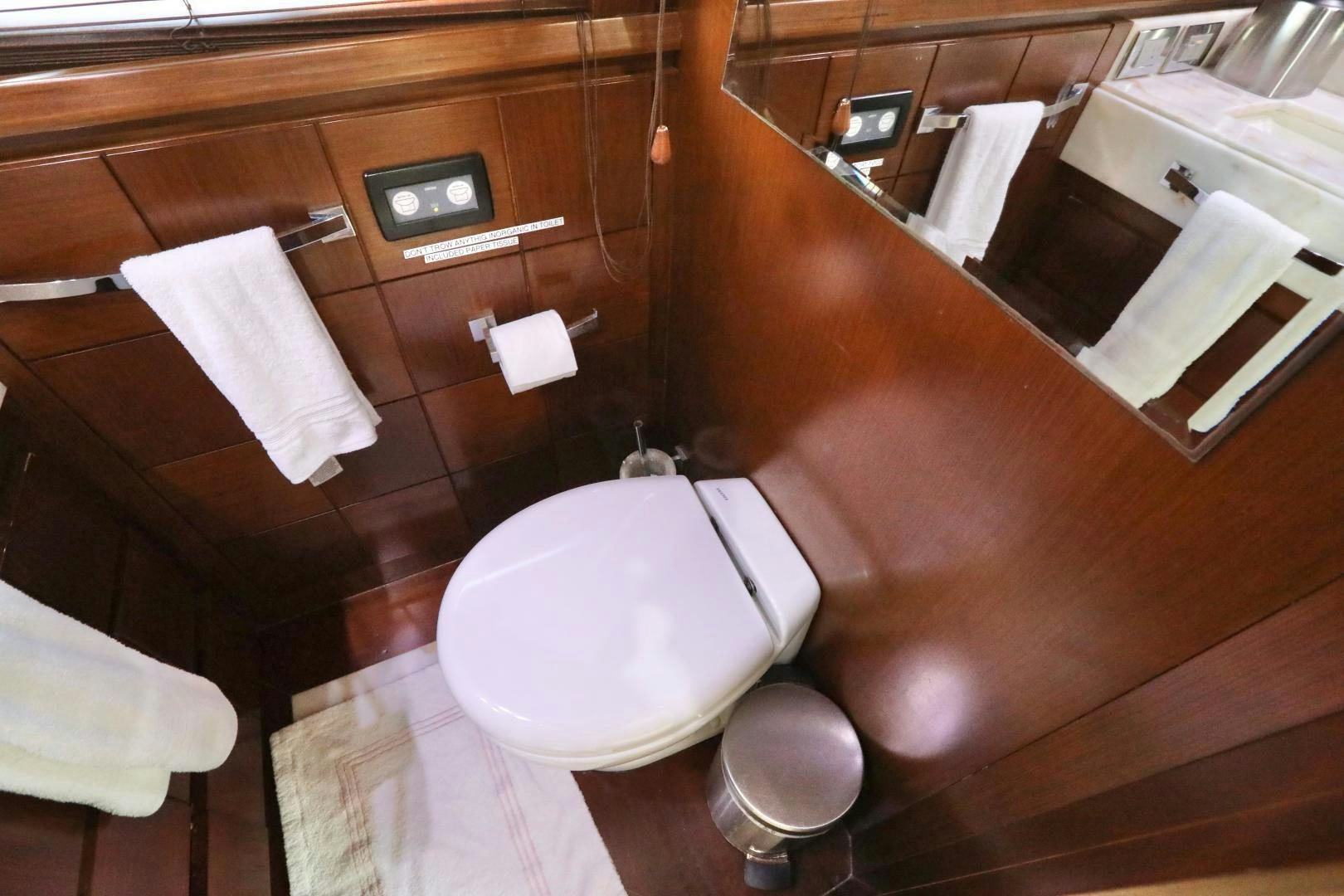a bathroom with a toilet and a mirror aboard ANDREIKA Yacht for Sale