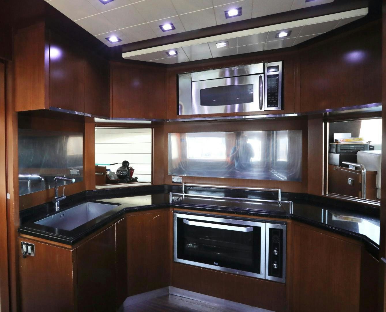 a kitchen with wooden cabinets aboard ANDREIKA Yacht for Sale