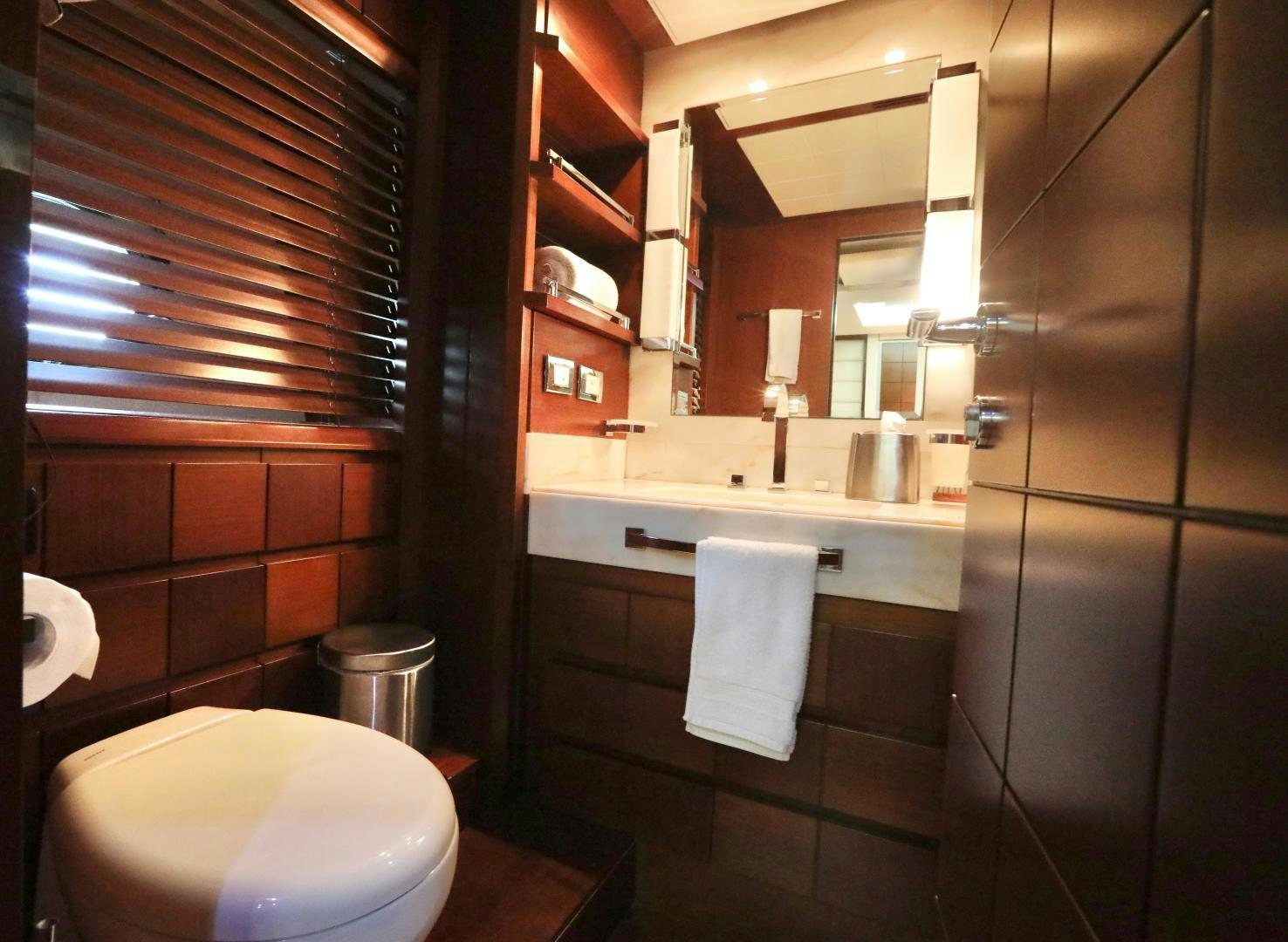 a bathroom with a toilet and a mirror aboard ANDREIKA Yacht for Sale