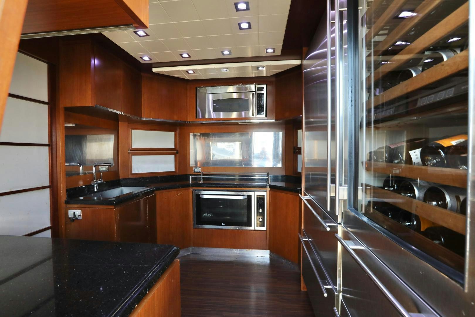 a kitchen with wooden cabinets aboard ANDREIKA Yacht for Sale