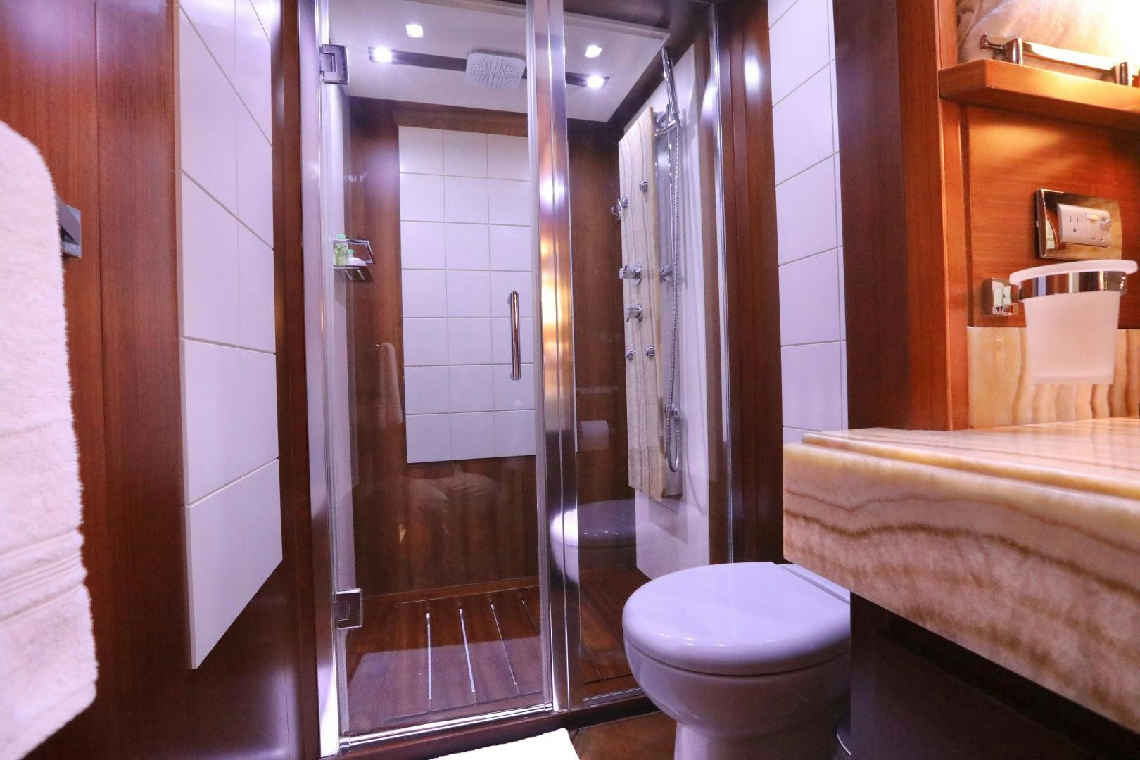 a bathroom with a glass shower aboard ANDREIKA Yacht for Sale