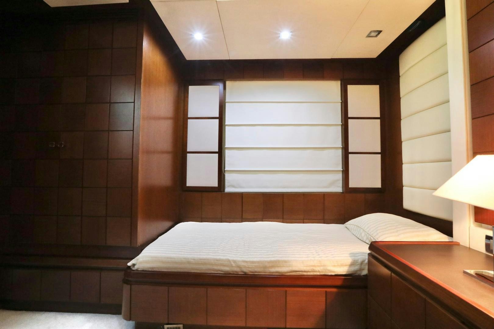 a bedroom with a bed and a window aboard ANDREIKA Yacht for Sale