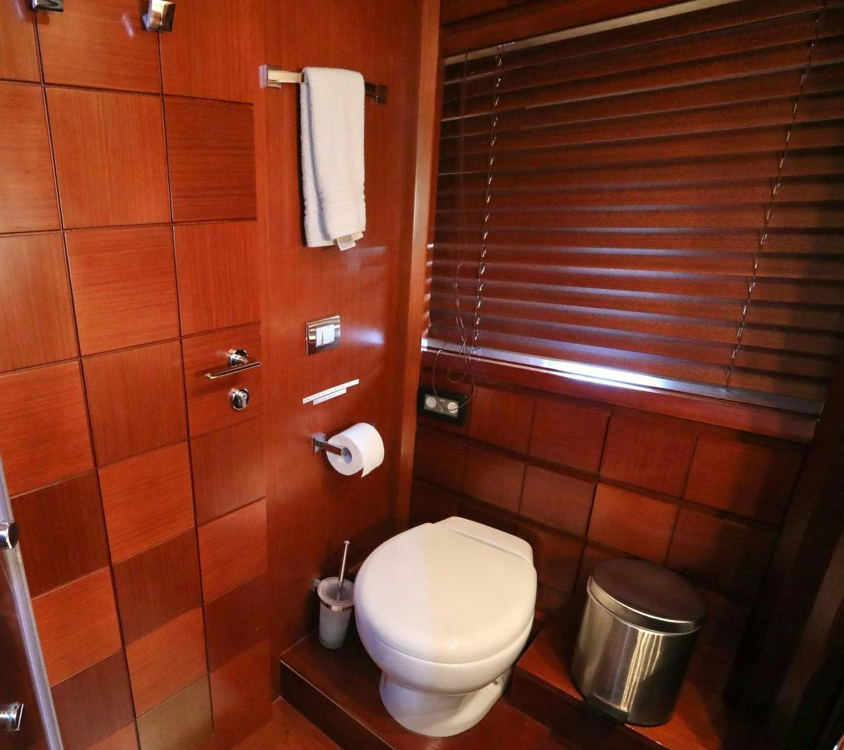 a toilet with a wooden wall aboard ANDREIKA Yacht for Sale
