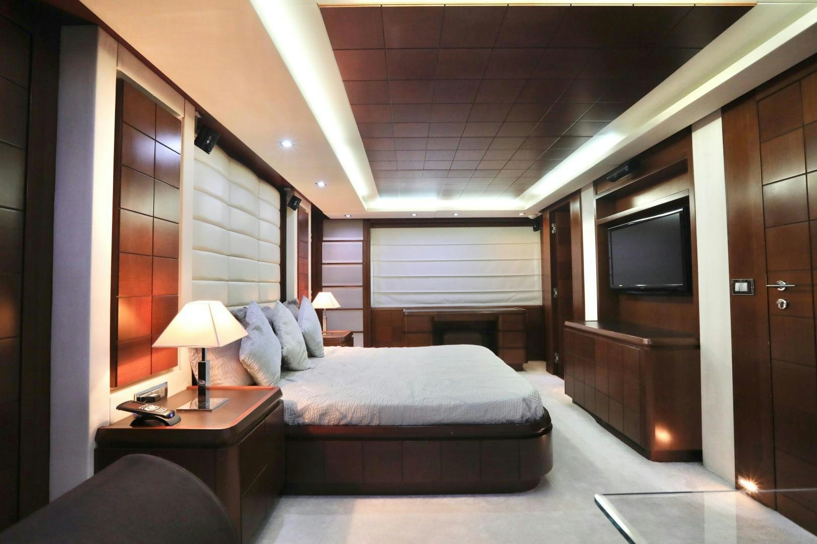 a hotel room with a bed and a television aboard ANDREIKA Yacht for Sale