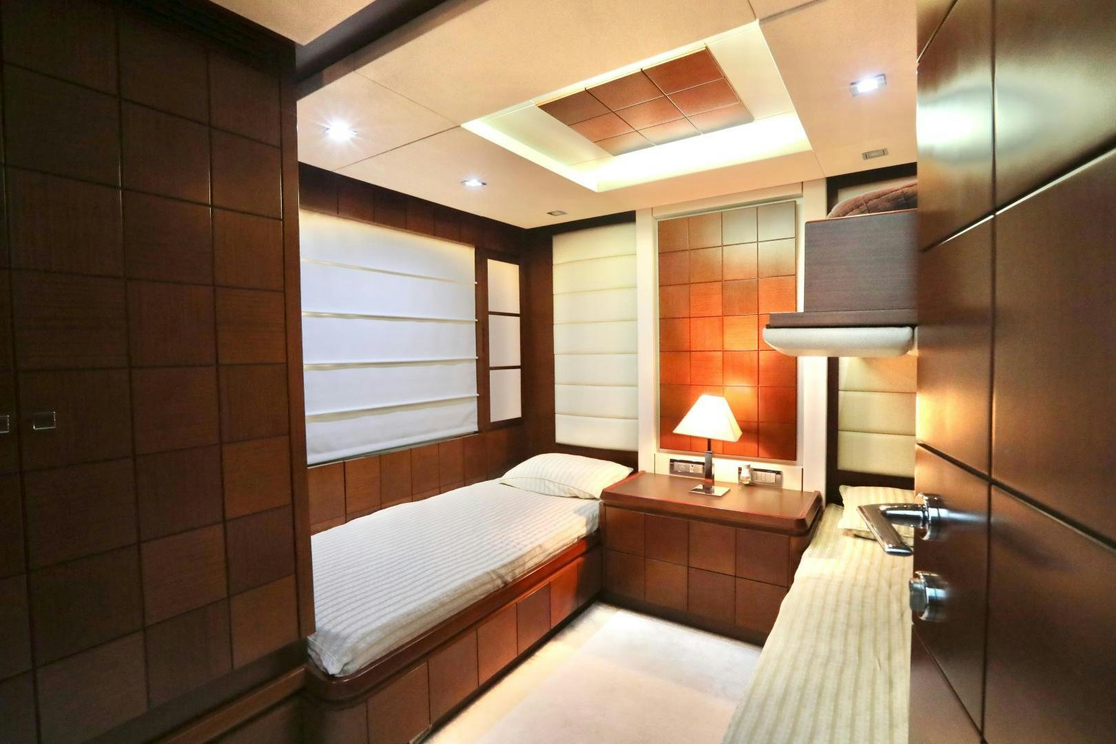 a room with a bed and a lamp aboard ANDREIKA Yacht for Sale