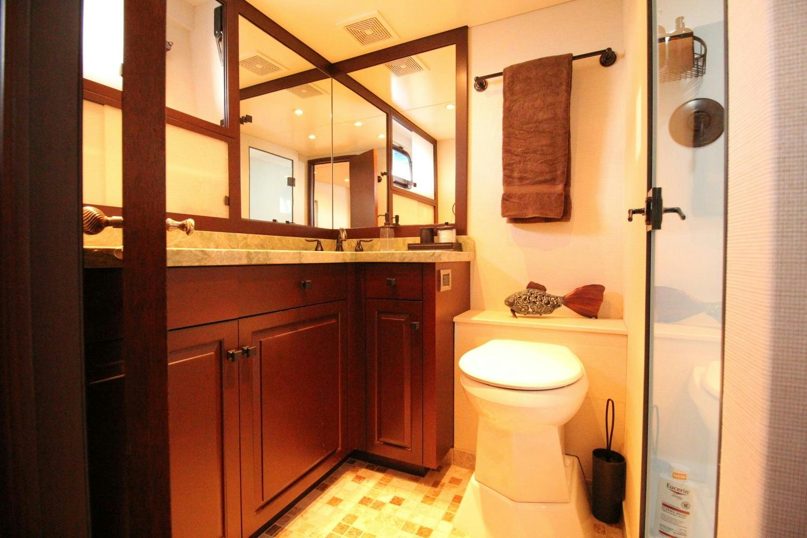 a bathroom with a toilet and a sink aboard REFLECTIONS Yacht for Sale