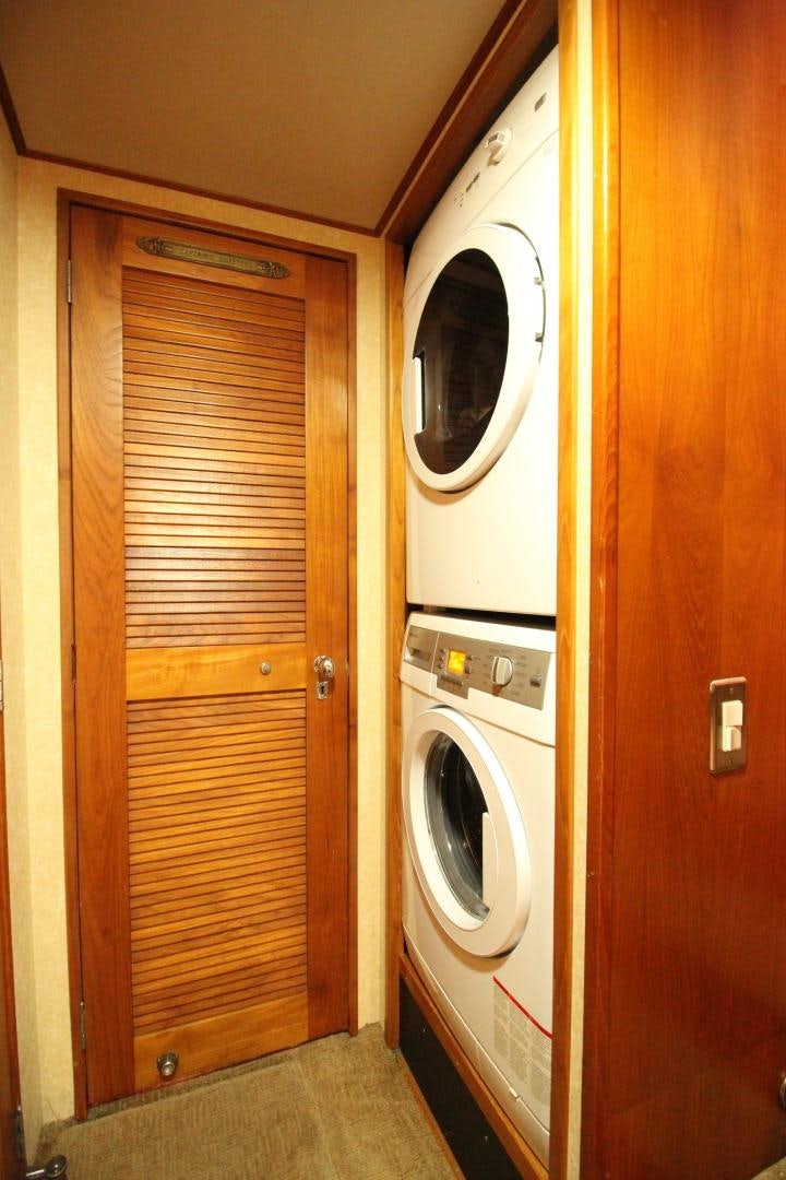 a closet with a washer and dryer aboard REFLECTIONS Yacht for Sale