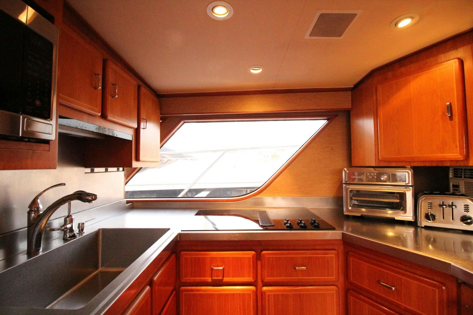 a kitchen with wooden cabinets aboard REFLECTIONS Yacht for Sale