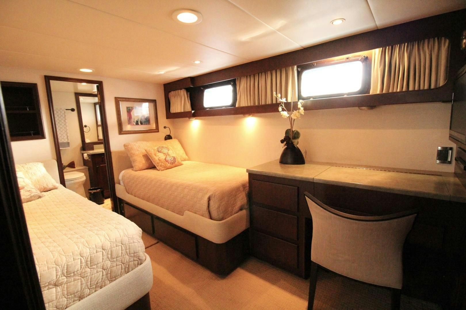 a hotel room with a bed and a desk aboard REFLECTIONS Yacht for Sale