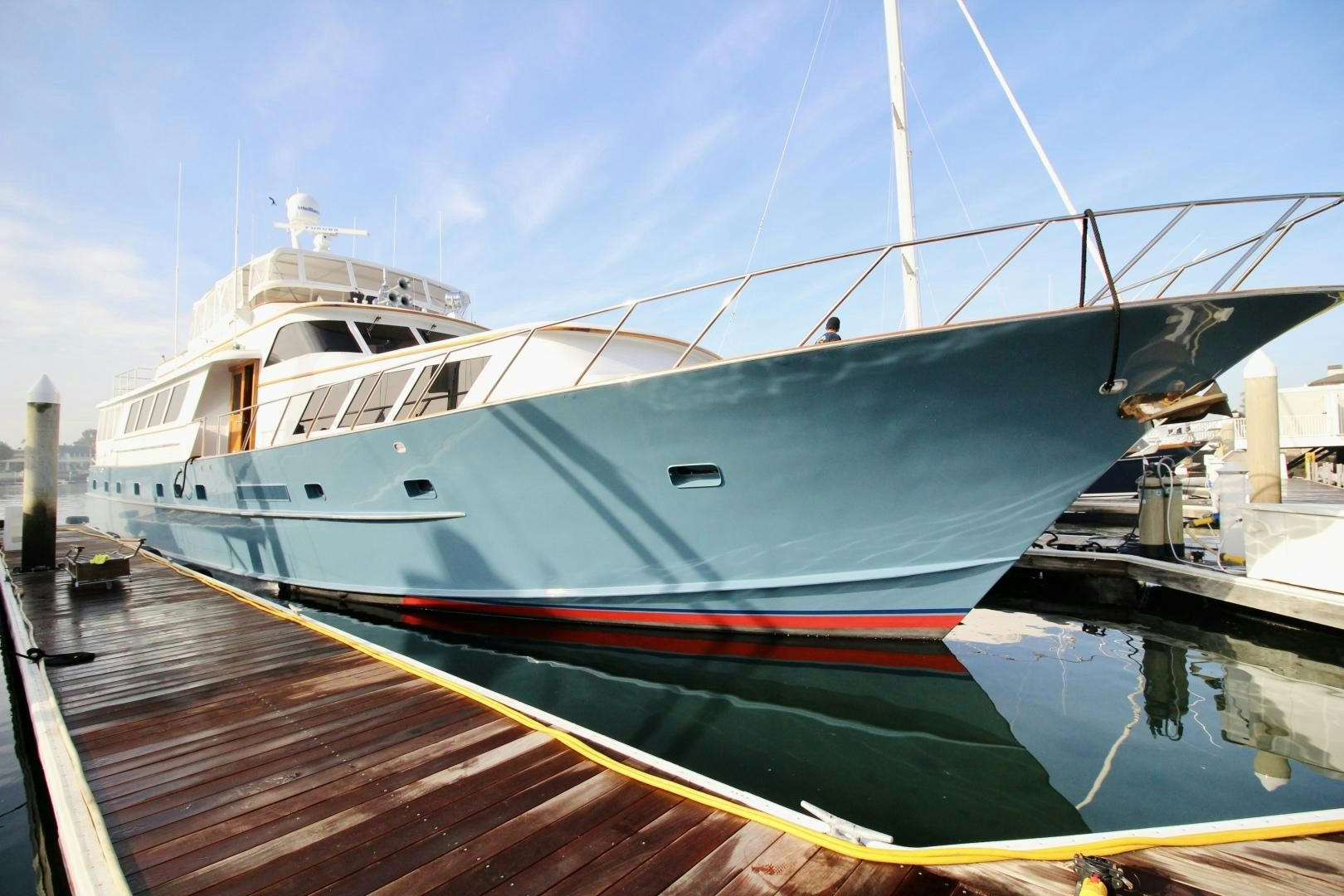 a large white boat docked aboard REFLECTIONS Yacht for Sale