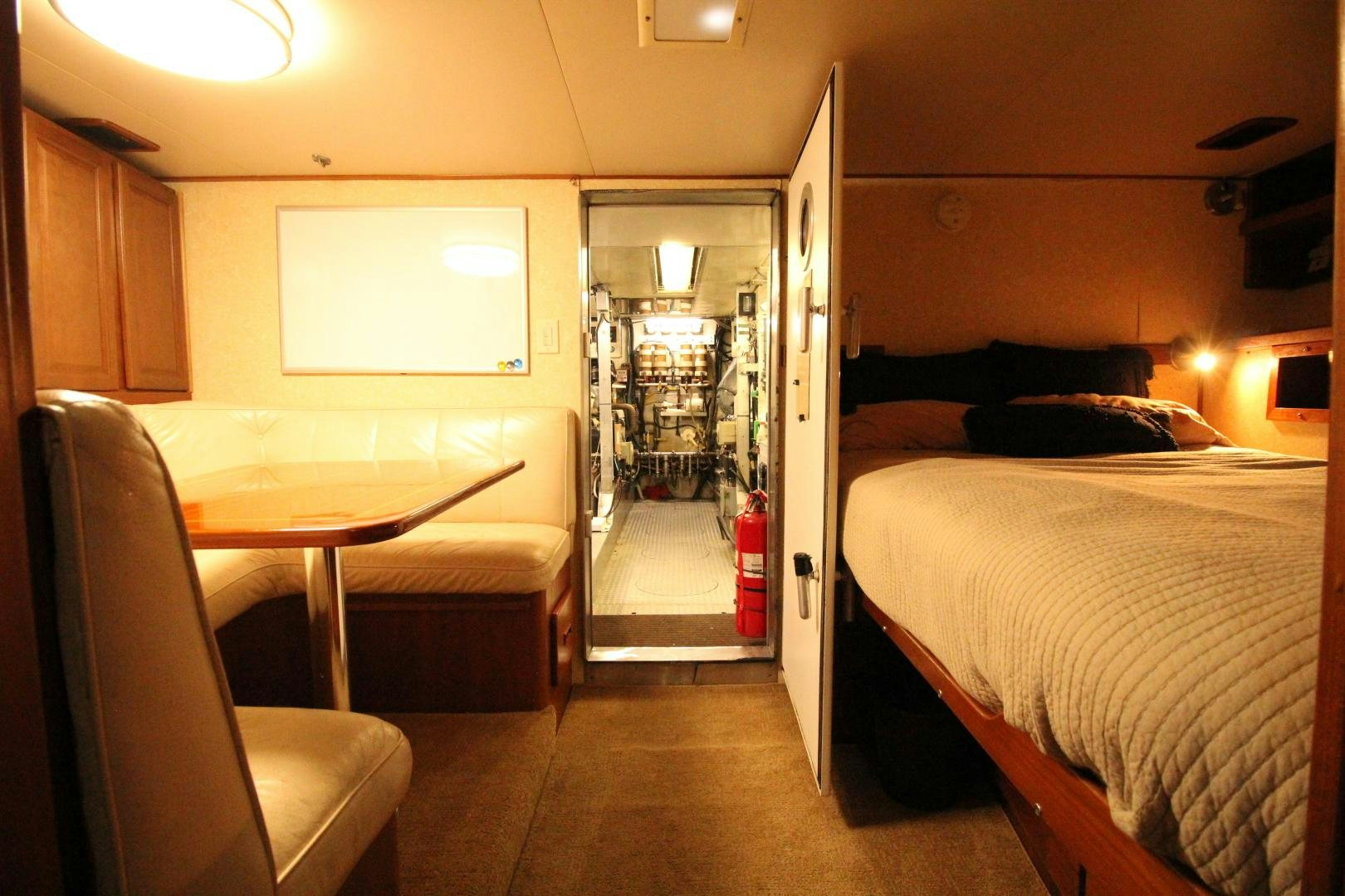 a bedroom with a bed and a table aboard REFLECTIONS Yacht for Sale