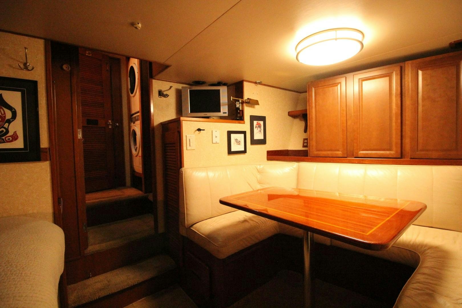 a small kitchen with a table aboard REFLECTIONS Yacht for Sale