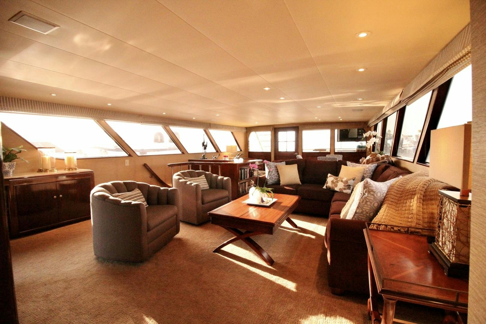 a living room with leather couches and a coffee table aboard REFLECTIONS Yacht for Sale