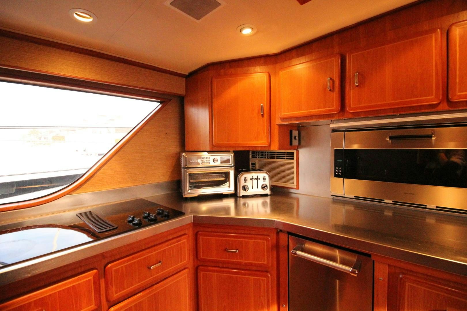a kitchen with wooden cabinets aboard REFLECTIONS Yacht for Sale