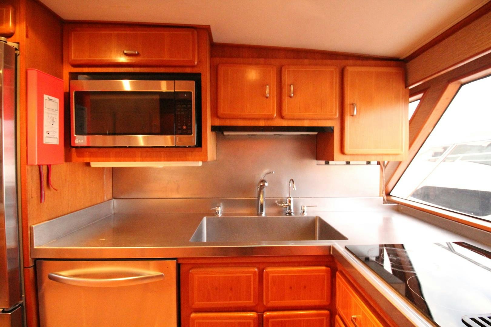 a kitchen with red cabinets aboard REFLECTIONS Yacht for Sale