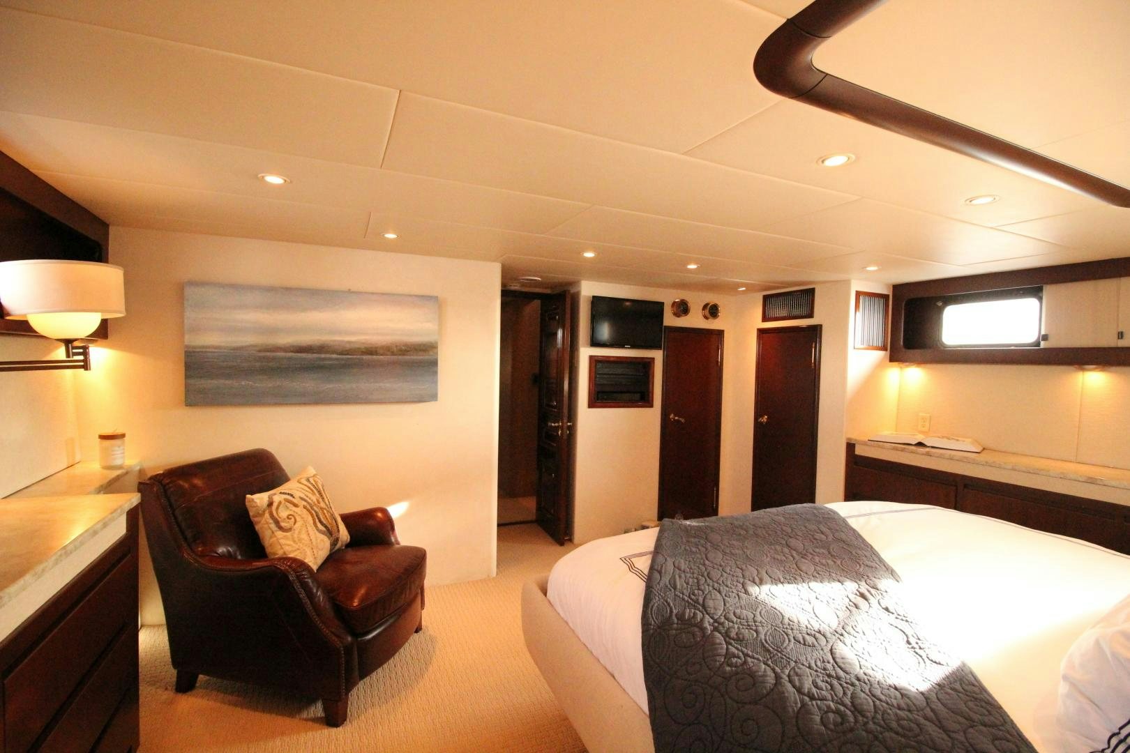a hotel room with a bed and a chair aboard REFLECTIONS Yacht for Sale