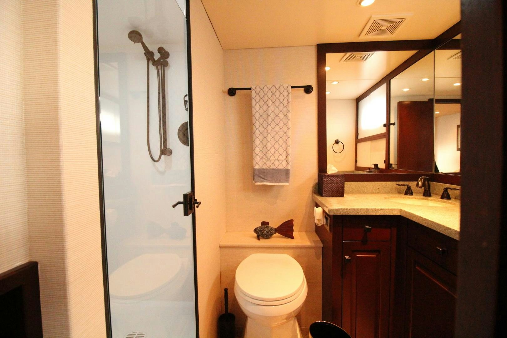 a bathroom with a toilet and a sink aboard REFLECTIONS Yacht for Sale