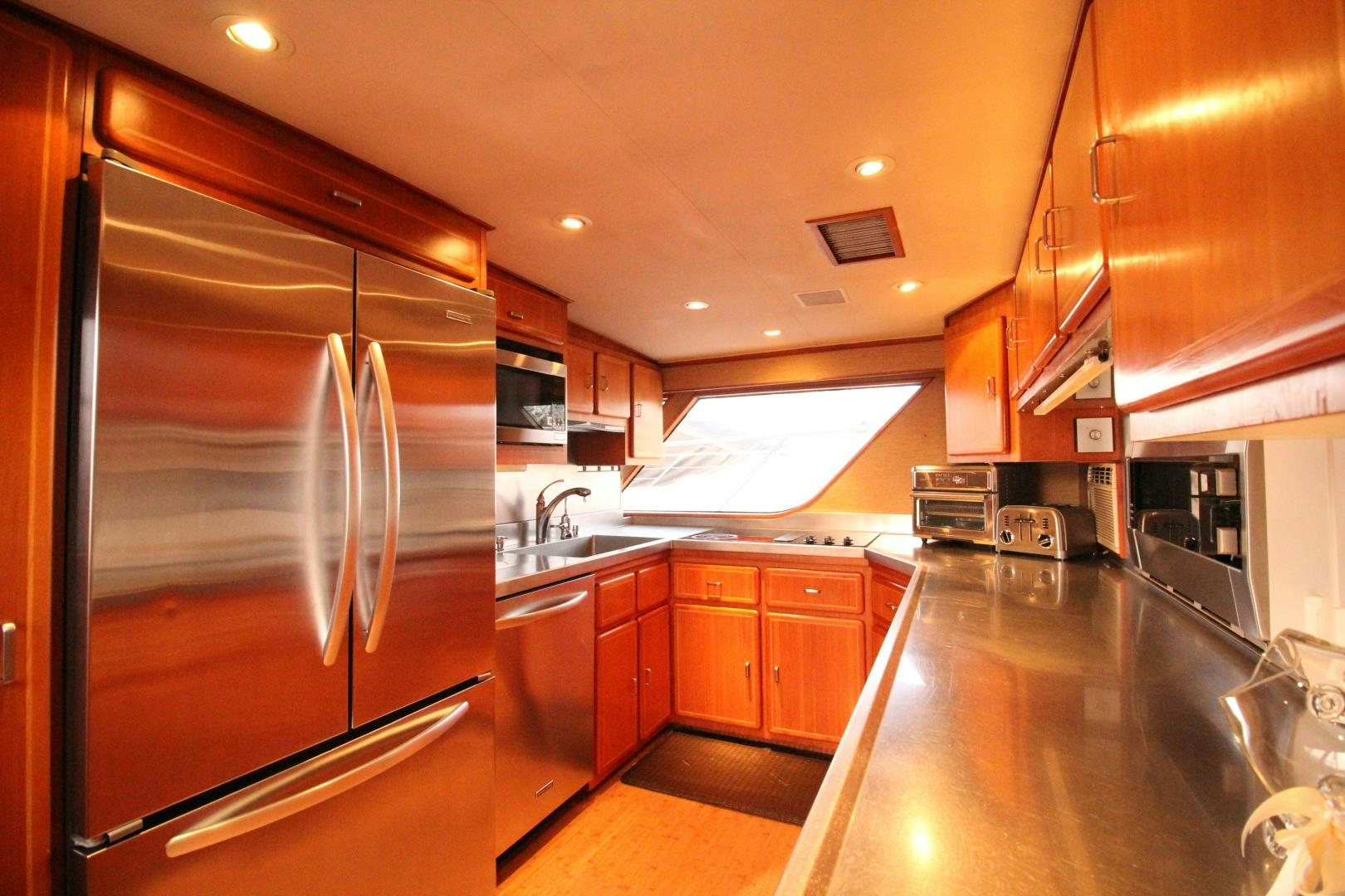 a kitchen with a large refrigerator aboard REFLECTIONS Yacht for Sale