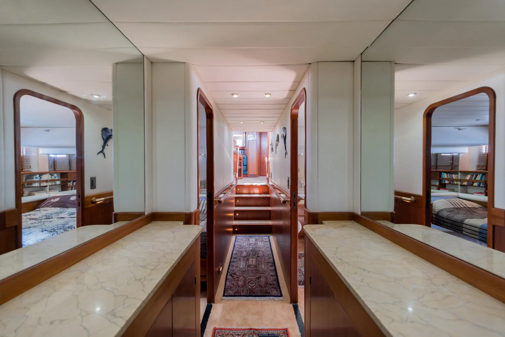 a room with a bed and a mirror aboard TARONGA Yacht for Sale