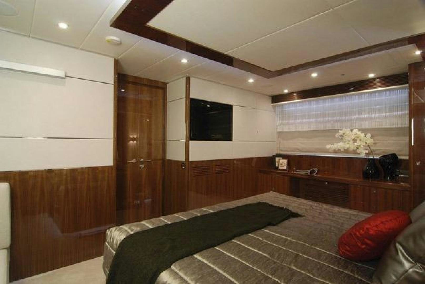 a bedroom with a bed and a tv aboard ENCORE Yacht for Sale