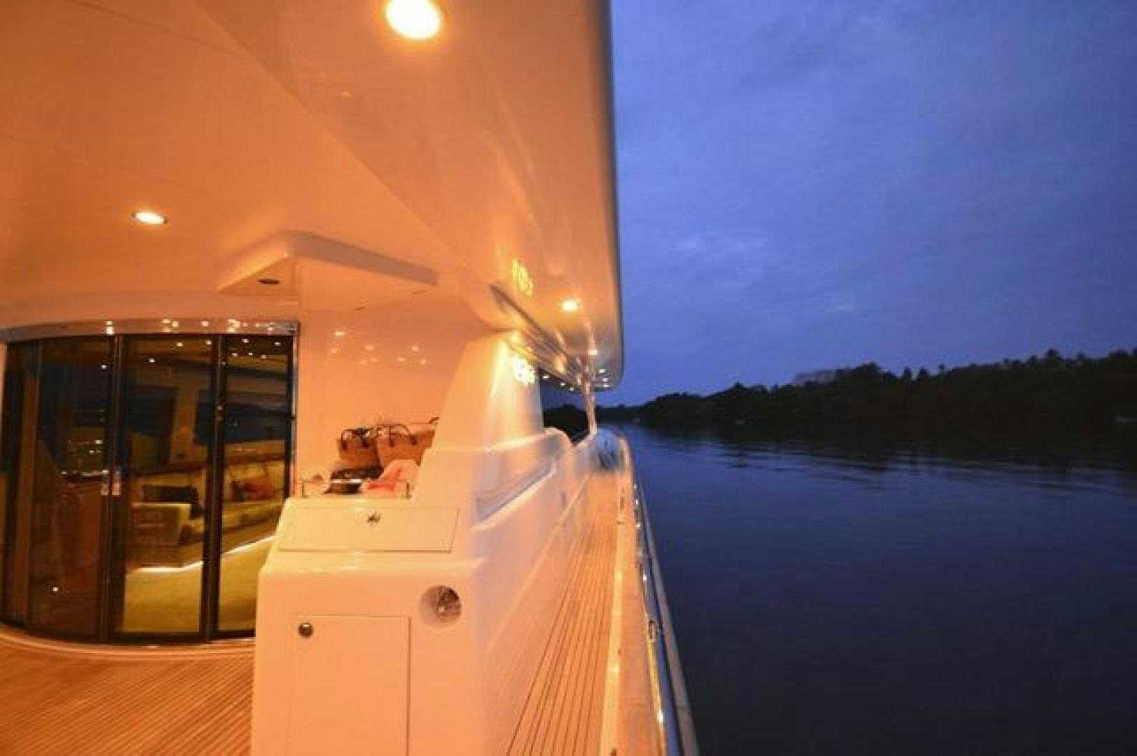 a boat with lights on the water aboard ENCORE Yacht for Sale