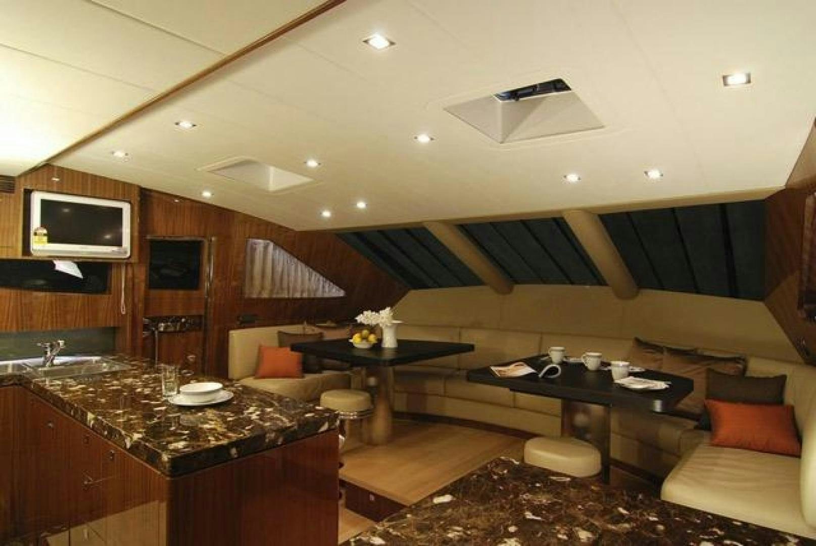 a room with a table and chairs aboard ENCORE Yacht for Sale