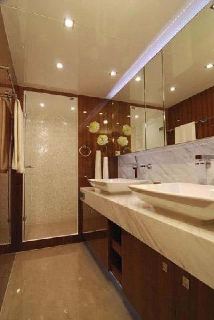 a bathroom with sinks and mirrors aboard ENCORE Yacht for Sale