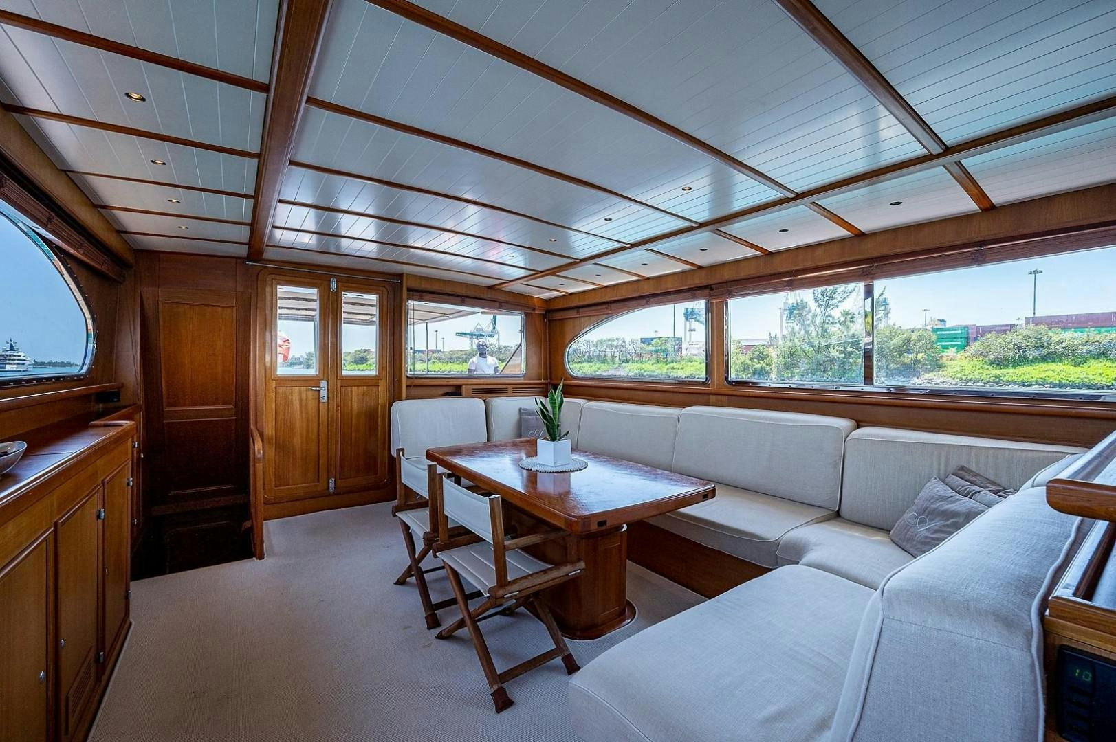 a living room with a couch and a table aboard ATALI Yacht for Sale