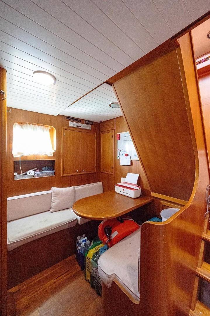 a room with a bed and a table aboard ATALI Yacht for Sale