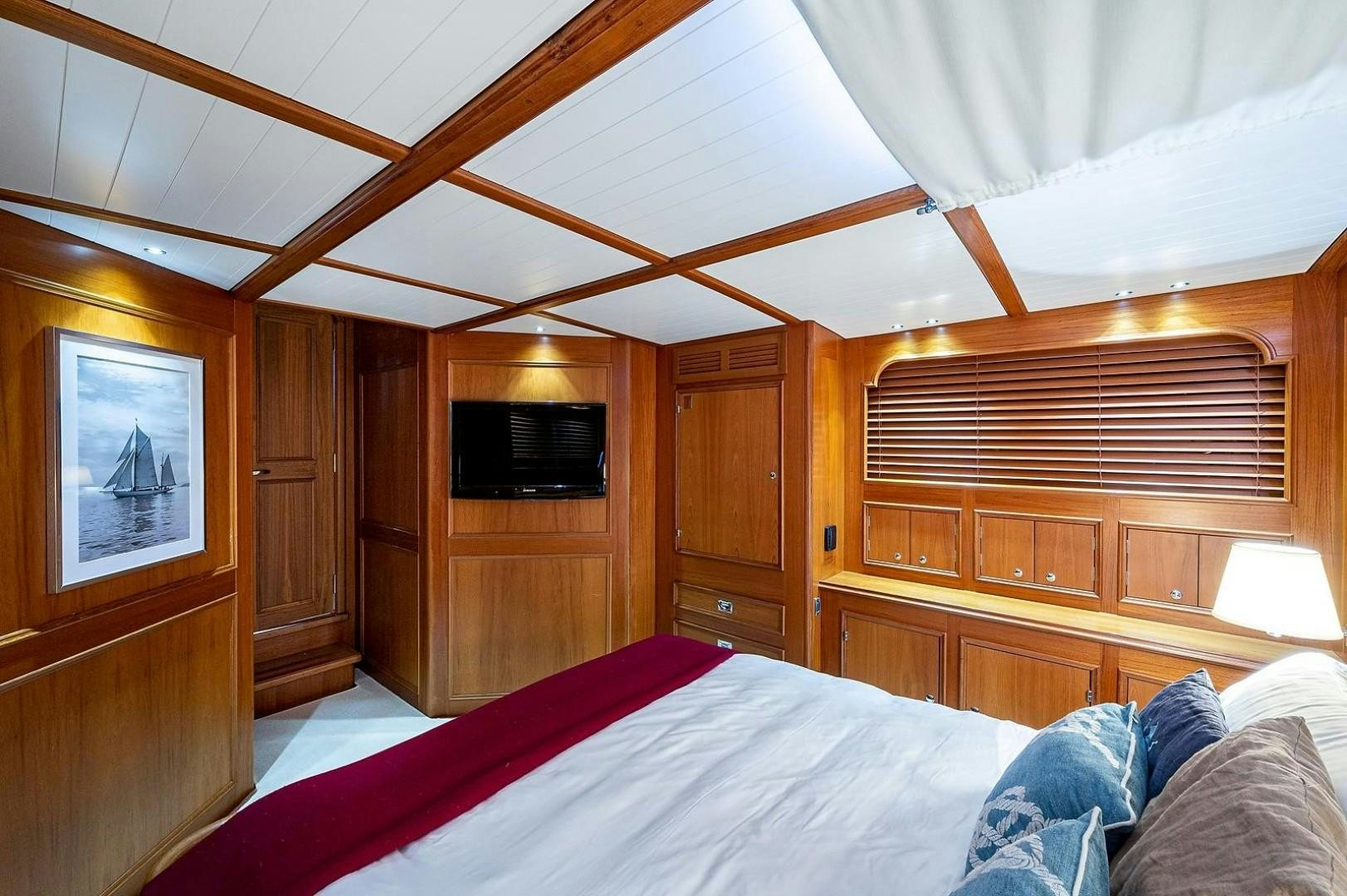 a room with a bed and a television aboard ATALI Yacht for Sale
