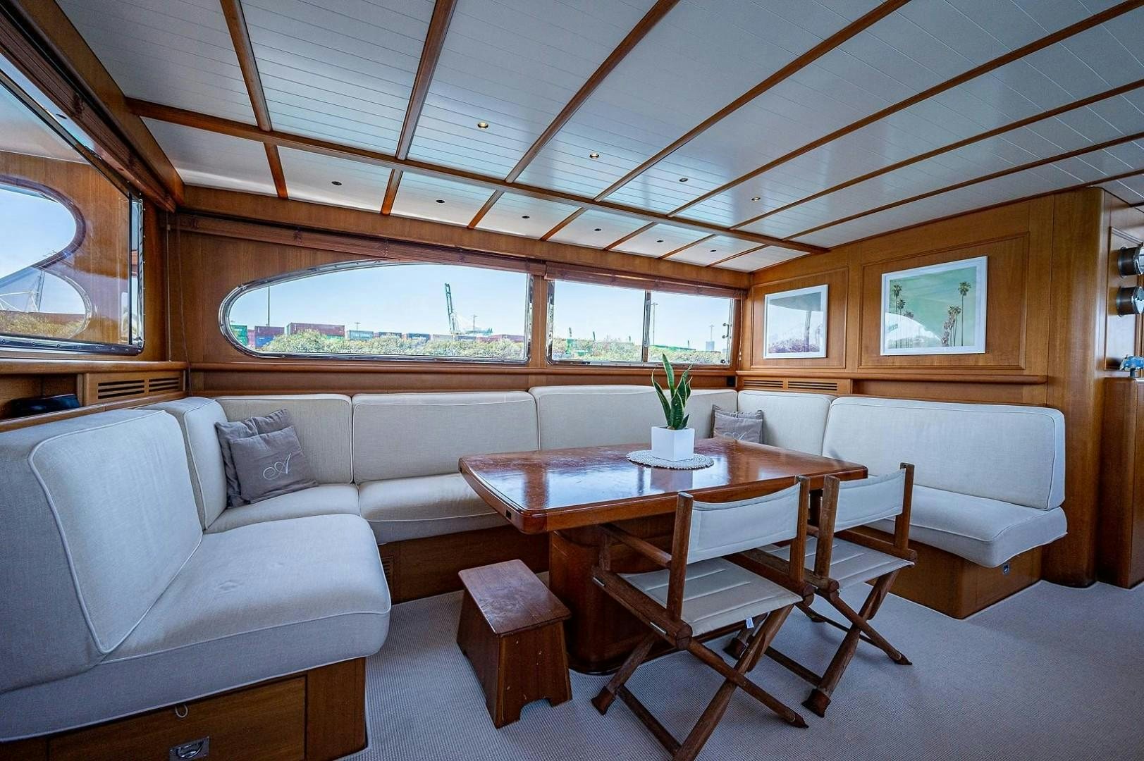 a room with a couch and a table and a window aboard ATALI Yacht for Sale