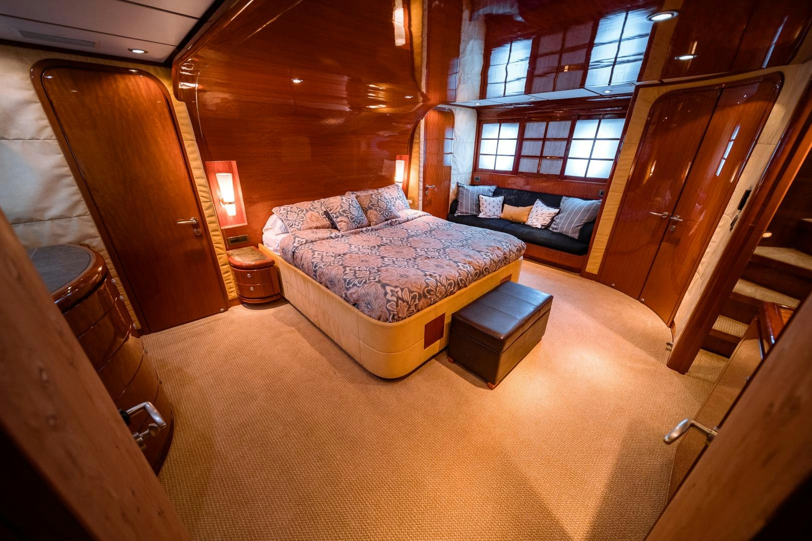 a room with a bed and a couch aboard ANDIAMO Yacht for Sale